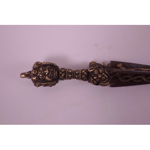 11 - A Sino-Tibetan bronzed metal ceremonial phurba, the handle decorated with a vajra, mythical creature... 