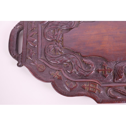 15 - An Oriental carved hardwood tray decorated with dragons and symbols, 24