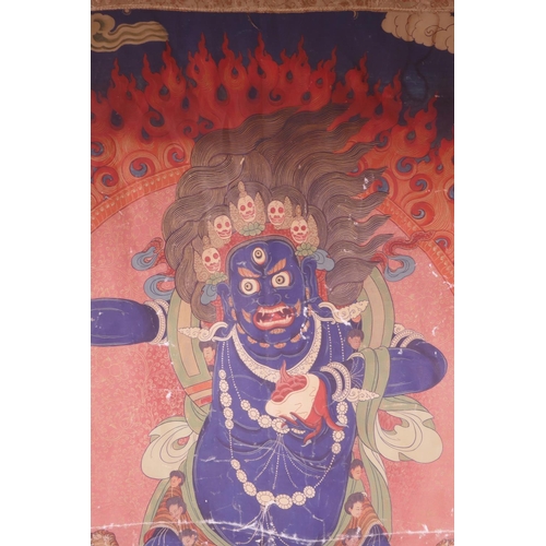 24 - A Sino-Tibetan printed thangka depicting a wrathful deity, with a silk surround, 30½