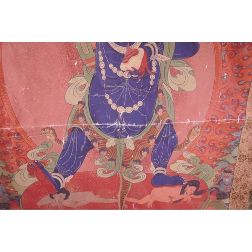 24 - A Sino-Tibetan printed thangka depicting a wrathful deity, with a silk surround, 30½