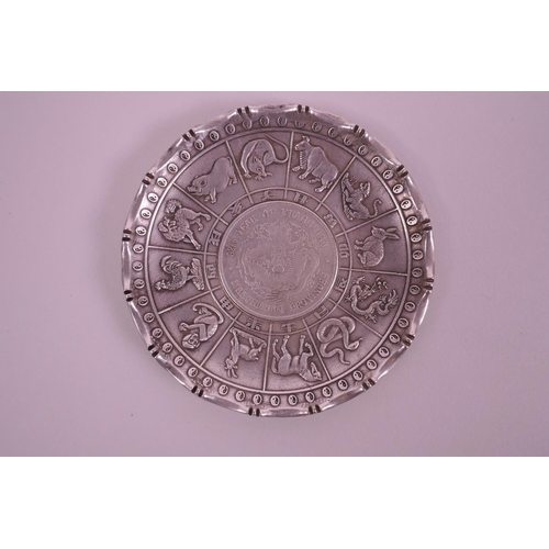 33 - A Chinese white metal coin dish depicting animals of the zodiac, 4