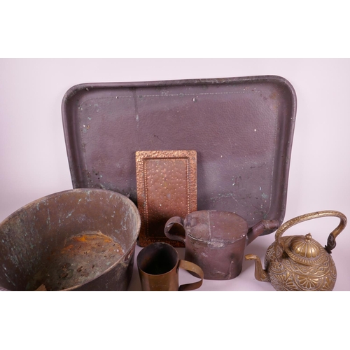 36 - A collection of brass and copper wares to include large copper trays, candles, teapots etc, largest ... 