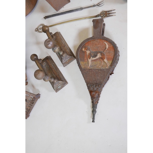 37 - A large collection of brass, copper and iron fire tools including bellows, dogs, chestnut roasters, ... 