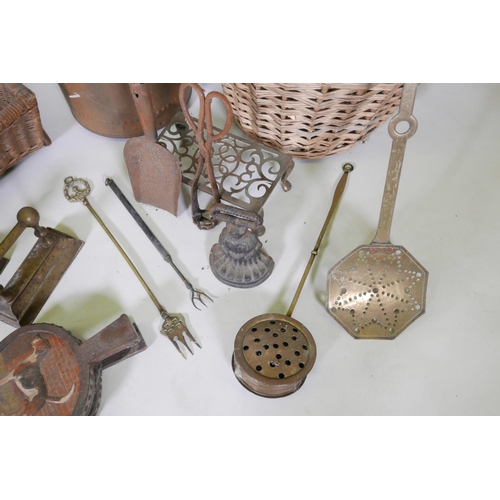 37 - A large collection of brass, copper and iron fire tools including bellows, dogs, chestnut roasters, ... 