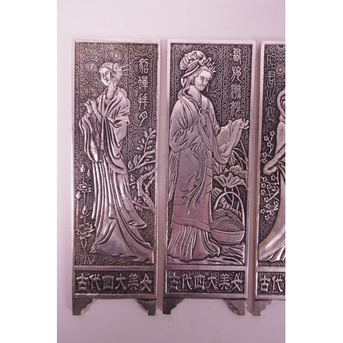 4 - Four Chinese white metal scroll weights in the form of panel screens, decorated with women, 2