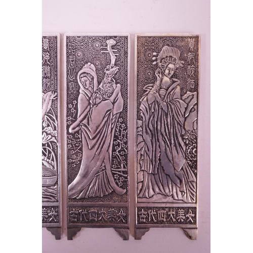 4 - Four Chinese white metal scroll weights in the form of panel screens, decorated with women, 2