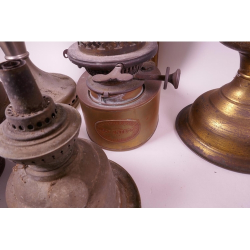 49 - A collection of assorted oil lamps, together with two boxes of spare glass chimneys and burners