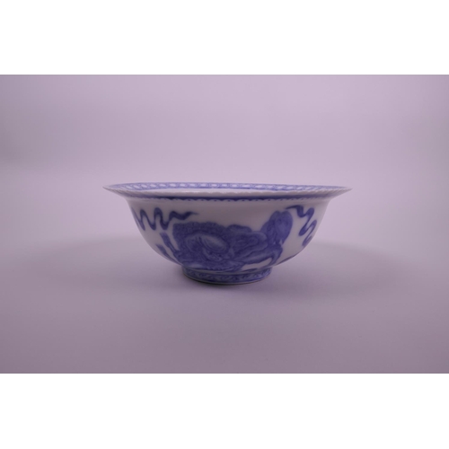 5 - A Chinese blue and white porcelain bowl with a frilled rim, decorated with kylin, bats and auspiciou... 