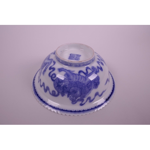 5 - A Chinese blue and white porcelain bowl with a frilled rim, decorated with kylin, bats and auspiciou... 