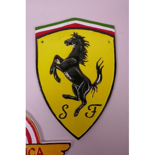 6 - Three painted cast iron wall plaques in the form of motor racing badges, largest 11½