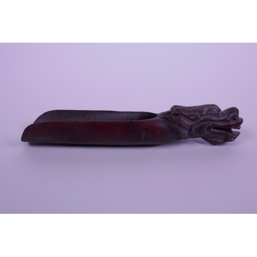 8 - A Chinese carved hardwood tea scoop with dragon head decoration to end, 5½