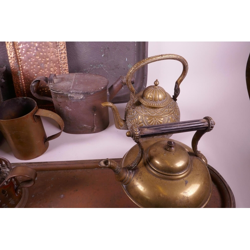 334 - A collection of brass and copper wares to include large copper trays, candles, teapots etc, largest ... 