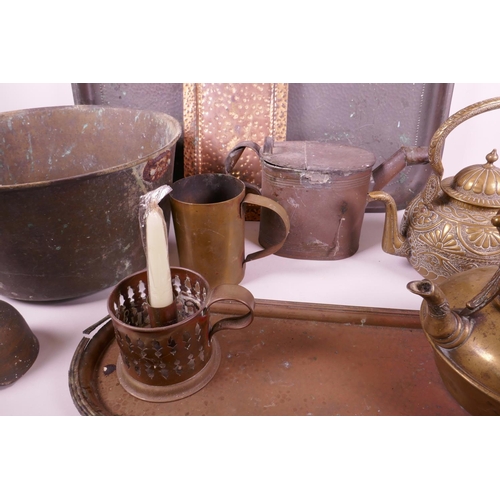 334 - A collection of brass and copper wares to include large copper trays, candles, teapots etc, largest ... 