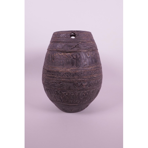 267 - A Continental black glazed terracotta jar with raised decoration of a wedding procession, 8½