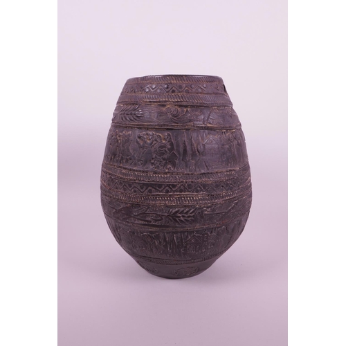 267 - A Continental black glazed terracotta jar with raised decoration of a wedding procession, 8½