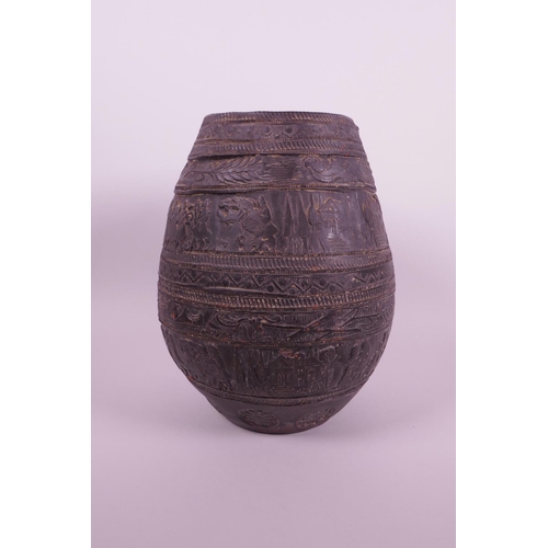 267 - A Continental black glazed terracotta jar with raised decoration of a wedding procession, 8½