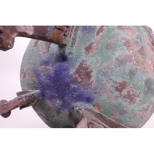 269 - A Chinese bronze ding on tripod feet with archaic decoration and two handles, inscribed to base, 14