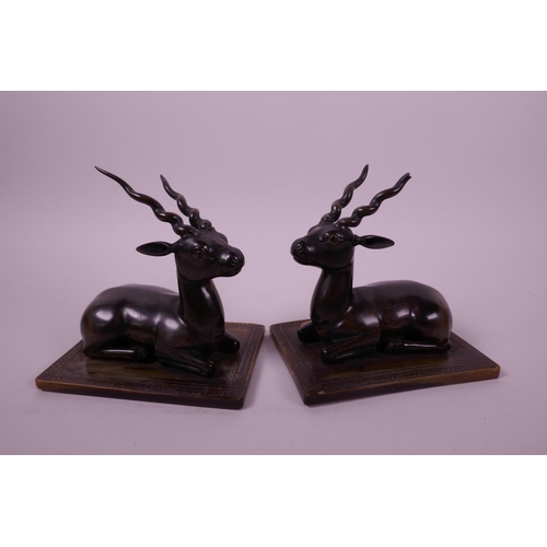 277 - A pair of late C19th carved rhino horn figures of antelope, mounted on horn bases, 4½