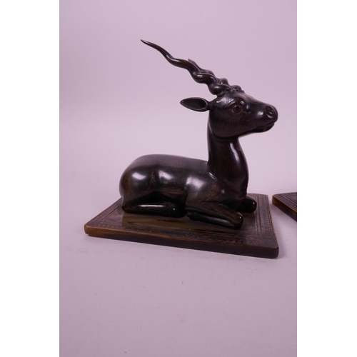 277 - A pair of late C19th carved rhino horn figures of antelope, mounted on horn bases, 4½