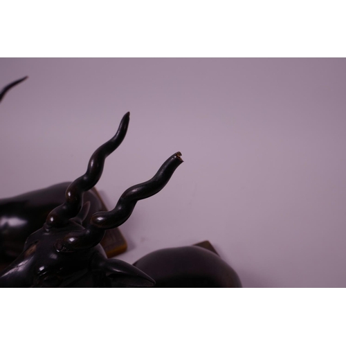 277 - A pair of late C19th carved rhino horn figures of antelope, mounted on horn bases, 4½