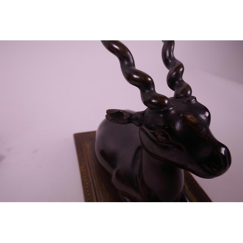 277 - A pair of late C19th carved rhino horn figures of antelope, mounted on horn bases, 4½