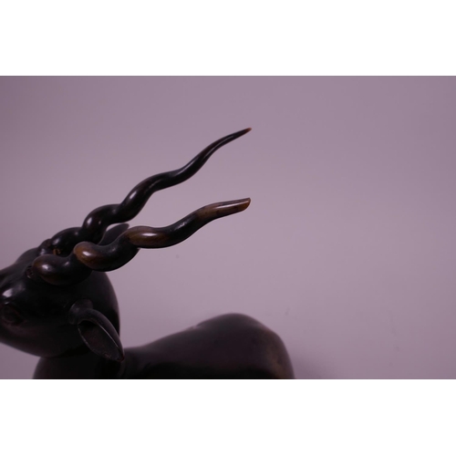 277 - A pair of late C19th carved rhino horn figures of antelope, mounted on horn bases, 4½