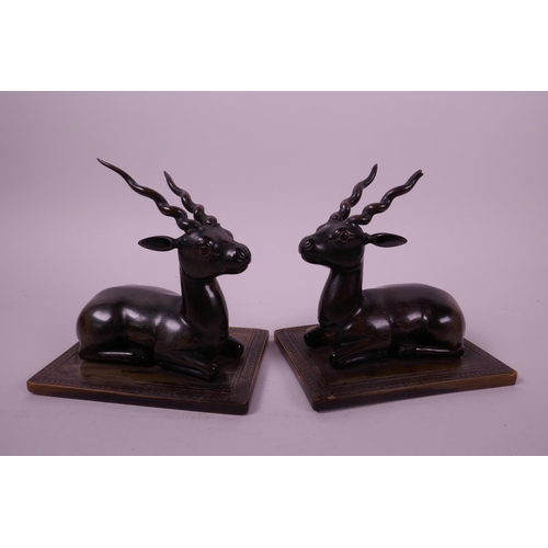 277 - A pair of late C19th carved rhino horn figures of antelope, mounted on horn bases, 4½