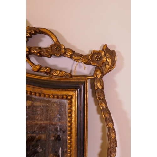 1177 - A contemporary wall mirror with pierced frame and ebonised and parcel gilt decoration, 57