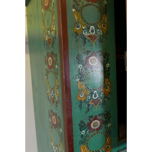 1168 - A C19th Continental painted pine armoire with two panelled doors and folk art inspired decoration, 4... 