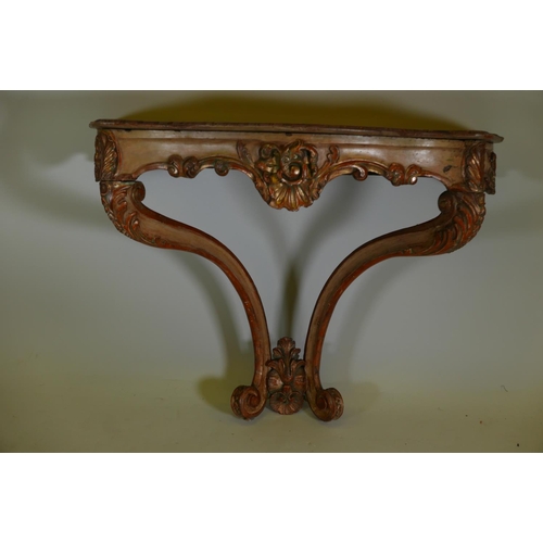 1170 - A C19th Italian painted and parcel gilt console table with shaped top and carved frieze, raised on s... 