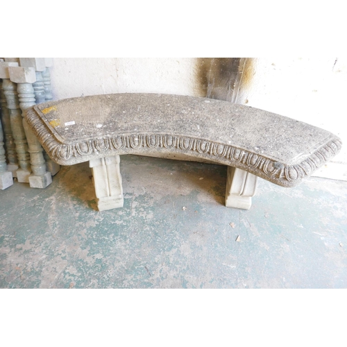 1172 - A reconsituted stone curved garden bench on pedestal supports