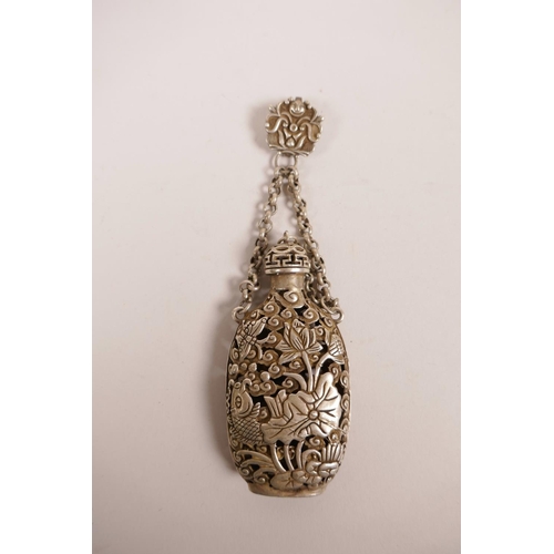 21 - A Chinese white metal scent holder pendant, with pierced fish, lotus flower and butterfly decoration... 