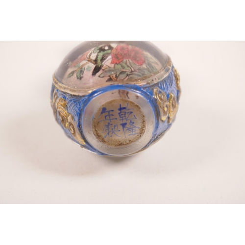 25 - A double gourd Peking glass snuff bottle with reverse painted panels decorated with birds and flower... 