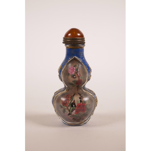 25 - A double gourd Peking glass snuff bottle with reverse painted panels decorated with birds and flower... 