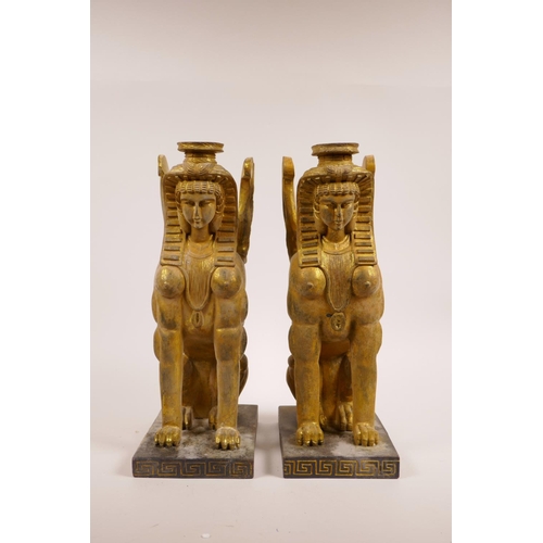 27 - A pair of gilt composition candlesticks of sphinx form, 12