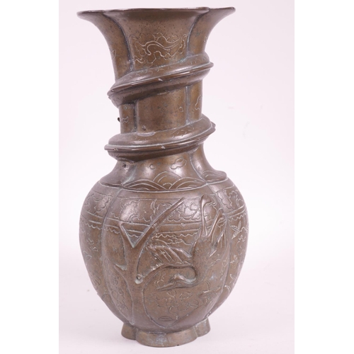 29 - An early C19th Chinese bronze vase with bulbous body and flared rim, the neck applied with an entwin... 