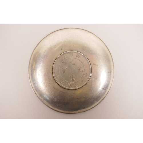 31 - A Chinese white metal coin dish with raised decoration of the emblems of the Eight Immortals, 4