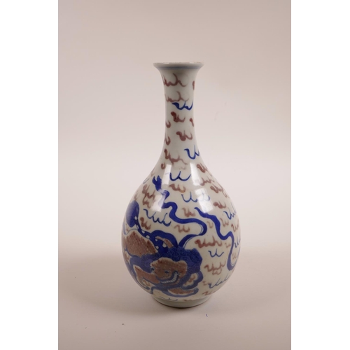 35 - A Chinese blue, white and red porcelain pear shaped vase with slender neck and kylin decoration, two... 