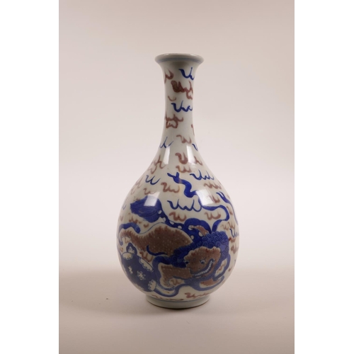 35 - A Chinese blue, white and red porcelain pear shaped vase with slender neck and kylin decoration, two... 