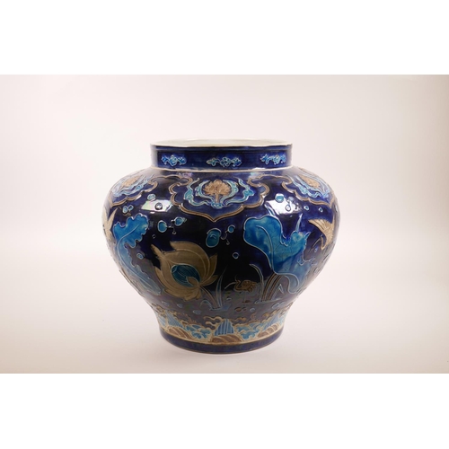 53 - A large Chinese blue ground pottery jardiniere with applied decoration of a lotus pond, 12