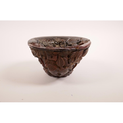 68 - A Chinese carved faux horn libation cup with bamboo forest decoration, seal mark to base, 7