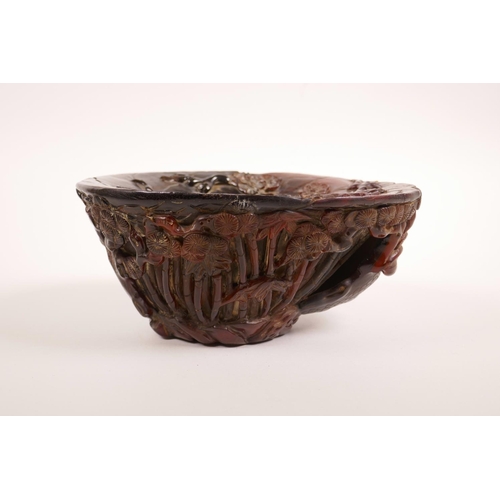 68 - A Chinese carved faux horn libation cup with bamboo forest decoration, seal mark to base, 7