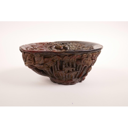 68 - A Chinese carved faux horn libation cup with bamboo forest decoration, seal mark to base, 7