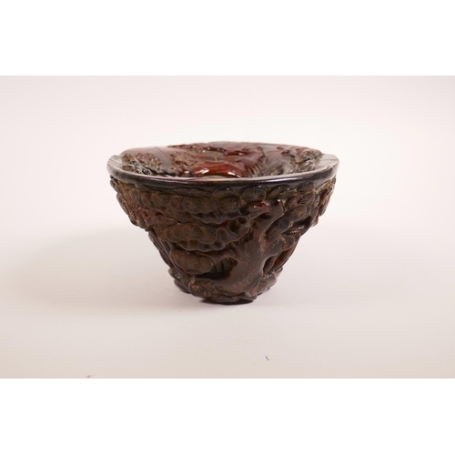 68 - A Chinese carved faux horn libation cup with bamboo forest decoration, seal mark to base, 7