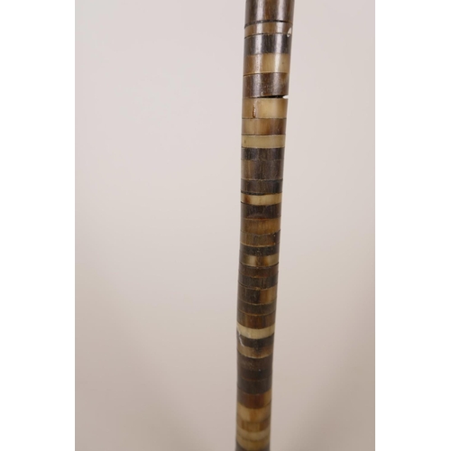 19 - A horn handled walking stick, possibly rhino, with a horn ringed shaft, 33½