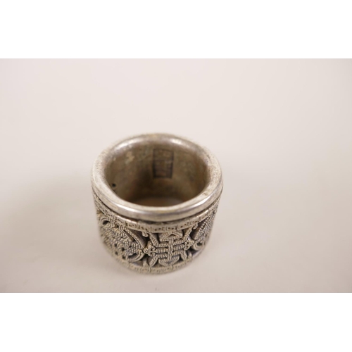 22 - A Chinese white metal archer's thumb ring with a revolving cuff decorated with auspicious symbols, 1... 