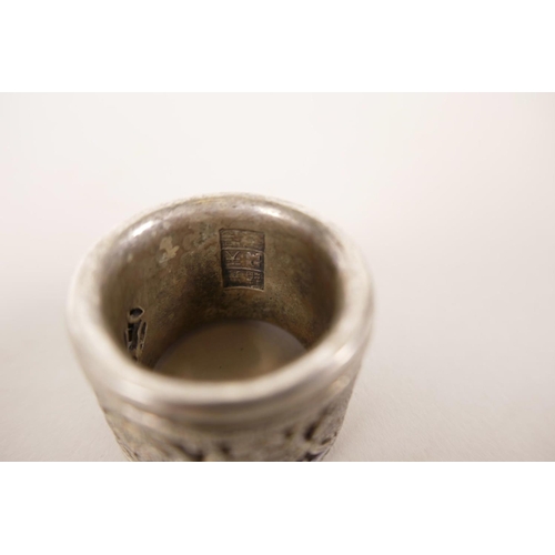 22 - A Chinese white metal archer's thumb ring with a revolving cuff decorated with auspicious symbols, 1... 