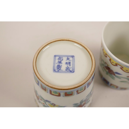 34 - A pair of Chinese doucai porcelain beakers with scrolling floral decoration, 6 character mark to bas... 