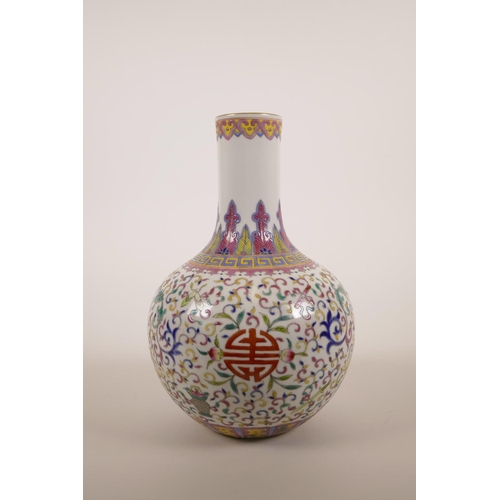 40 - A Chinese polychrome enamelled porcelain vase decorated with lotus flowers and the emblems of The Ei... 