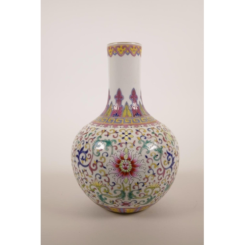 40 - A Chinese polychrome enamelled porcelain vase decorated with lotus flowers and the emblems of The Ei... 